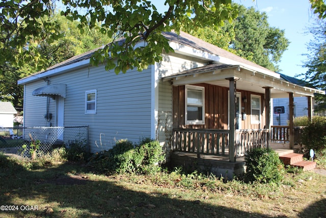 back of property with covered porch