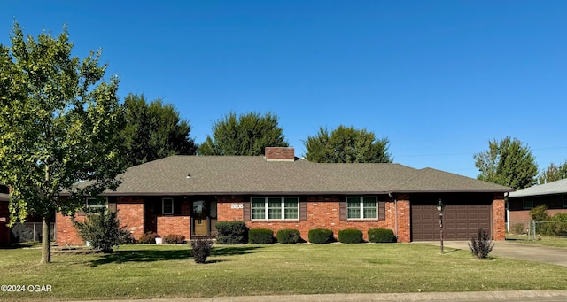 ranch-style home with a front yard and a garage