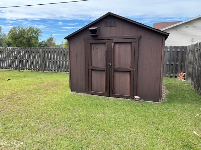 view of outbuilding featuring a lawn