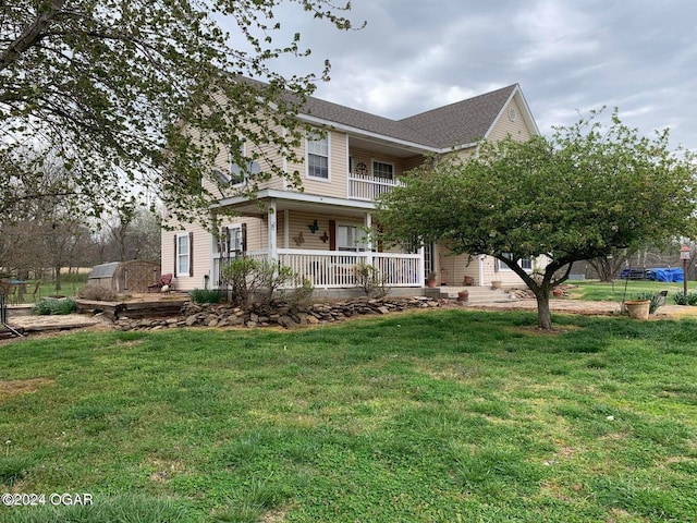 view of front of property featuring a balcony, covered porch, and a front lawn