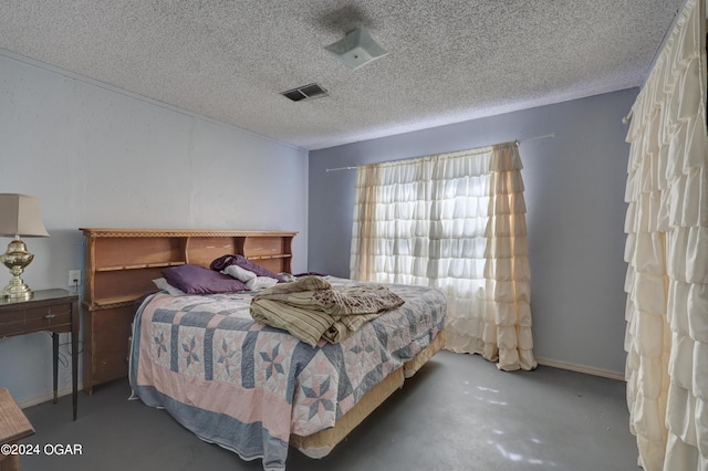 bedroom featuring concrete floors and a textured ceiling