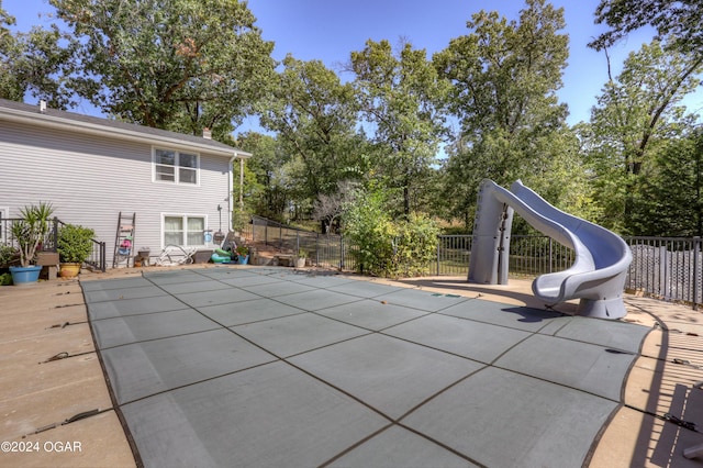 view of pool featuring a patio and a water slide