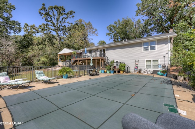 view of pool featuring a wooden deck and a patio area