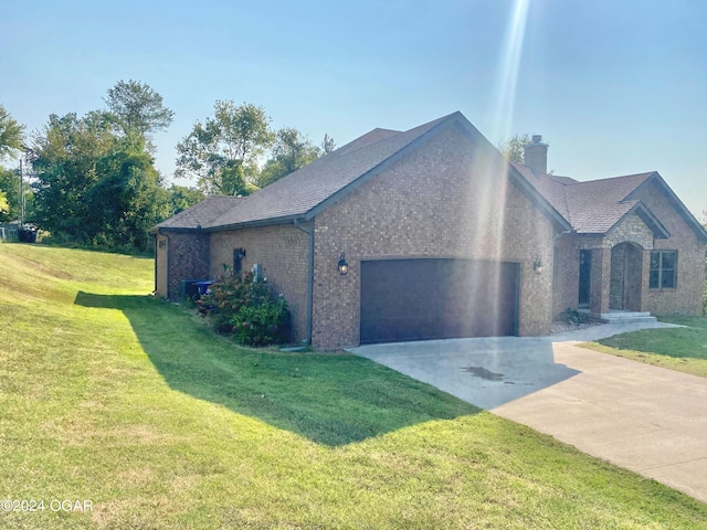 view of side of property featuring a yard and a garage