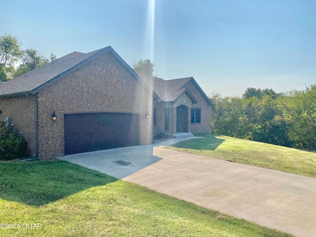 view of front facade with a garage and a front lawn