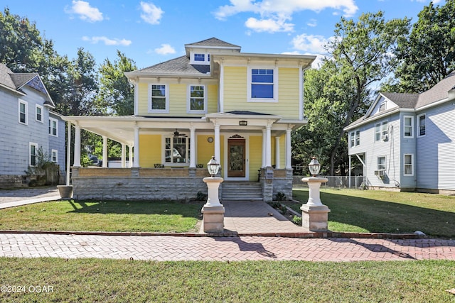 view of front of home featuring a front yard and covered porch