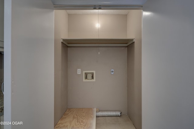 laundry area with hookup for an electric dryer, light tile patterned flooring, and washer hookup