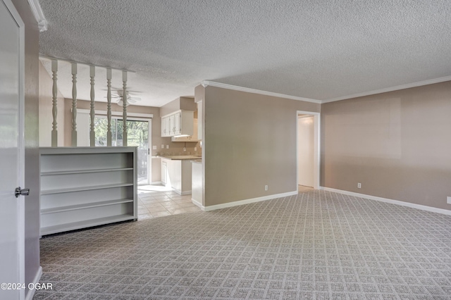 carpeted empty room featuring crown molding and a textured ceiling