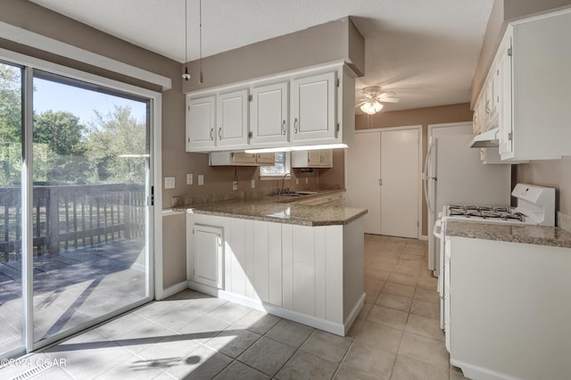 kitchen featuring white cabinets, sink, white gas range oven, and ceiling fan