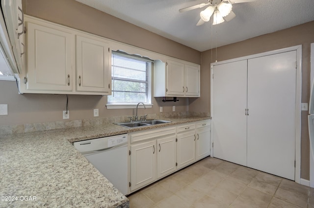 kitchen with a textured ceiling, white cabinetry, sink, and white appliances