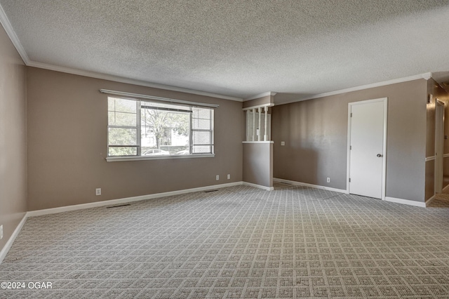 carpeted spare room featuring ornamental molding and a textured ceiling