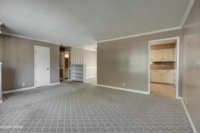 empty room with ornamental molding, light carpet, and a textured ceiling