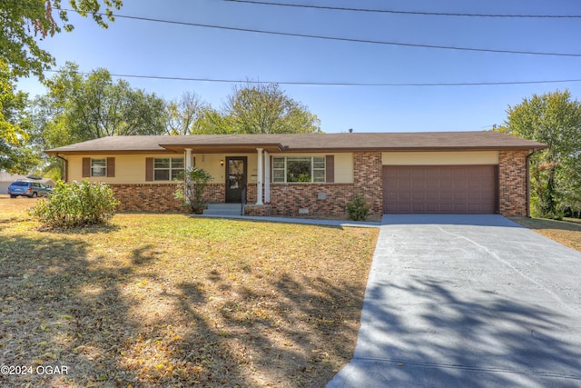 ranch-style home featuring a front lawn and a garage