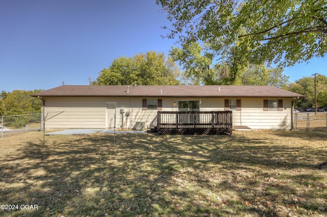 rear view of house with a yard and a deck