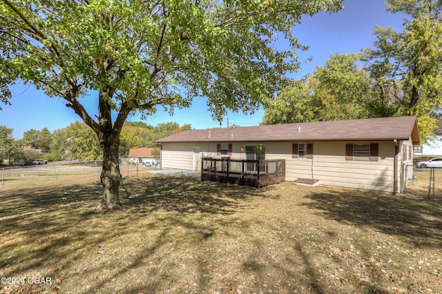 back of house featuring a yard and a deck