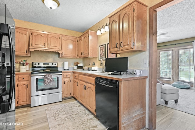 kitchen featuring a textured ceiling, stainless steel electric stove, black dishwasher, and light hardwood / wood-style flooring