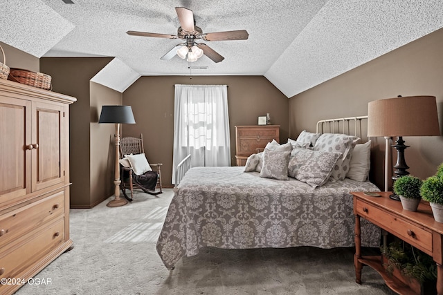 bedroom featuring a textured ceiling, lofted ceiling, ceiling fan, and light colored carpet