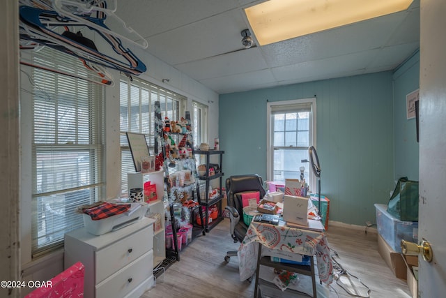 misc room featuring a paneled ceiling and light hardwood / wood-style flooring