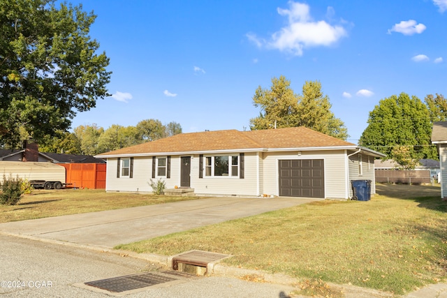 single story home featuring a front lawn and a garage