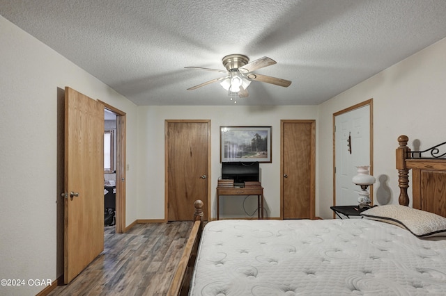 bedroom with hardwood / wood-style flooring, ceiling fan, and a textured ceiling