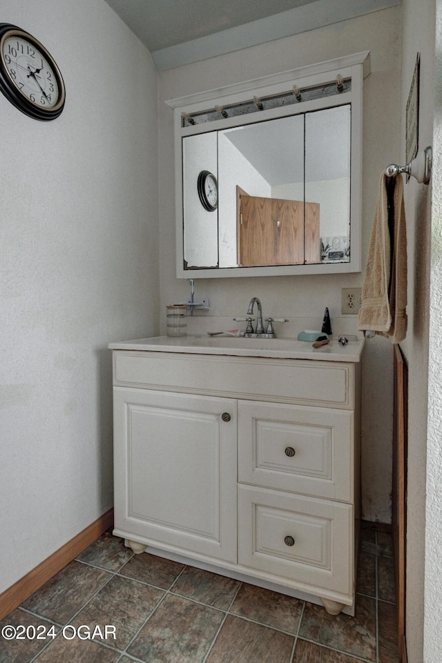 bathroom featuring tile patterned flooring and vanity