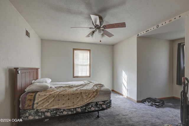 carpeted bedroom with a textured ceiling and ceiling fan