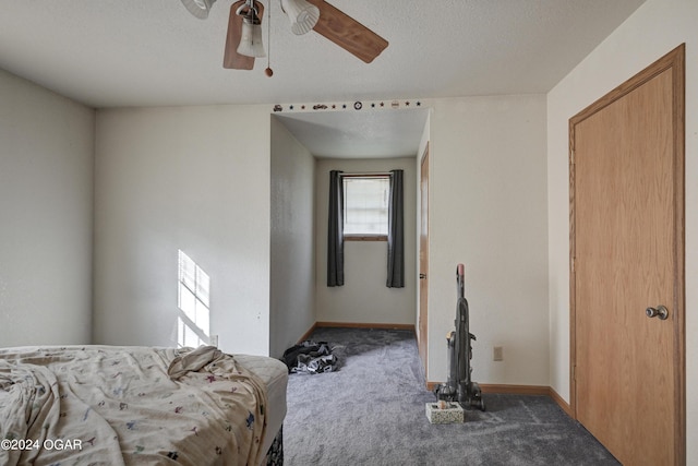 carpeted bedroom with ceiling fan and a textured ceiling