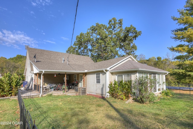 back of property with a lawn and a patio