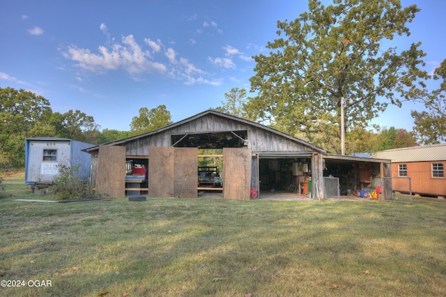 exterior space with an outdoor structure and a front lawn