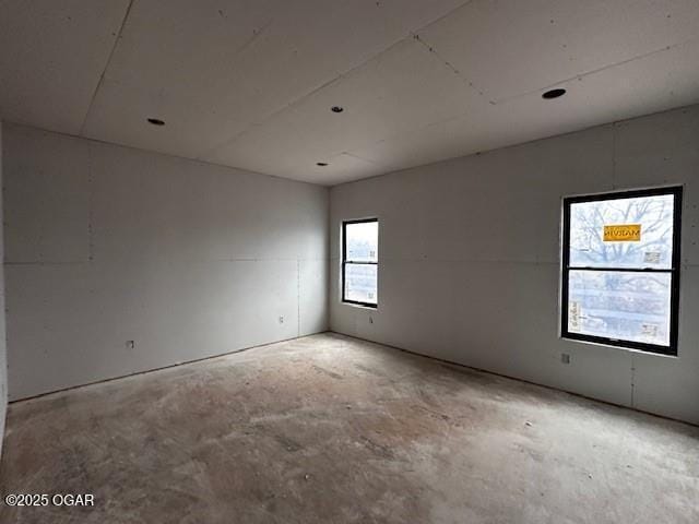 unfurnished room with concrete floors