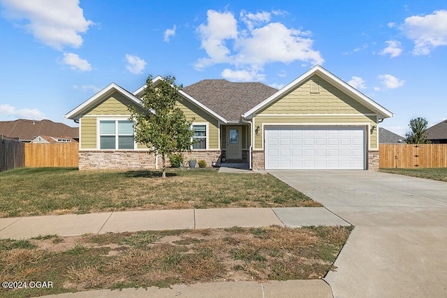 craftsman house with a front yard and a garage