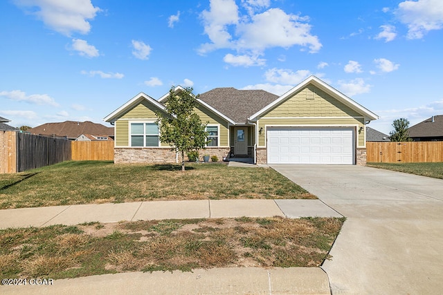 view of front of property with a front lawn and a garage