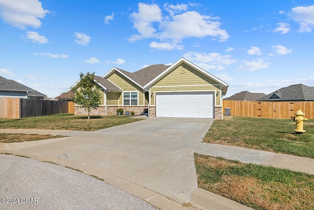 view of front of property with a front yard and a garage