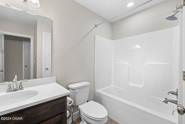 full bathroom with vanity, toilet, wood-type flooring, and tub / shower combination