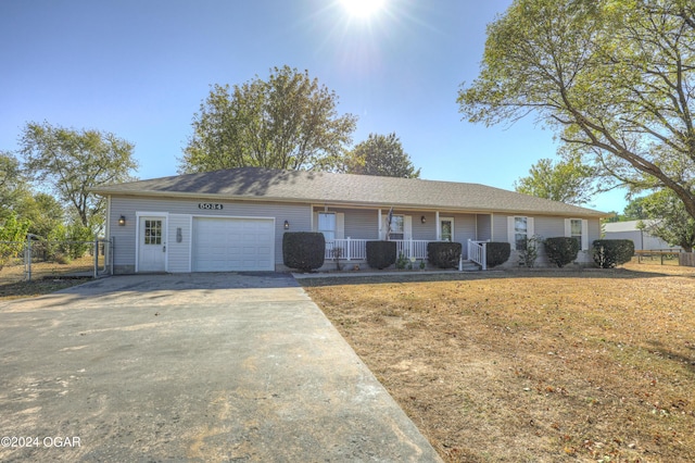 single story home featuring a garage, central AC unit, and a porch