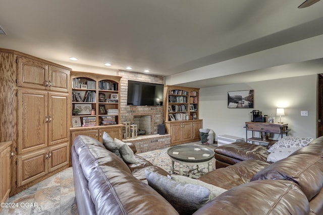 living room with a fireplace and built in features