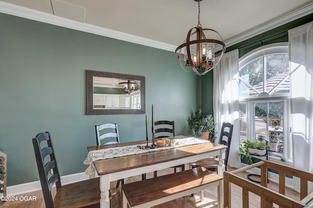 dining area featuring crown molding, a notable chandelier, and wood-type flooring