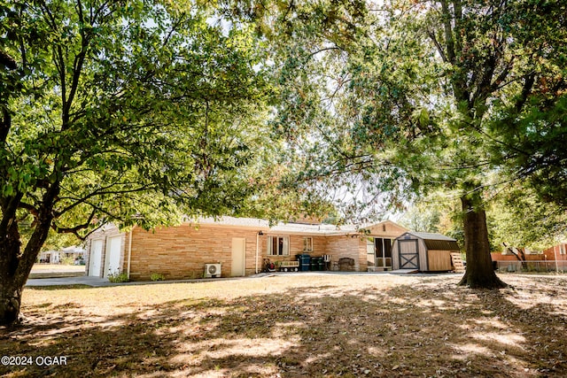 exterior space with a patio, a storage unit, and a garage