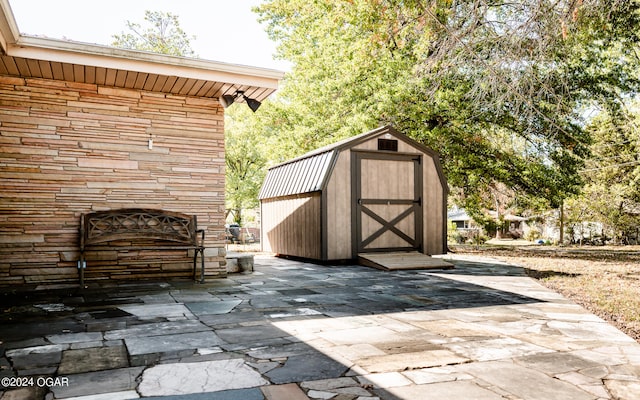 view of patio with a shed