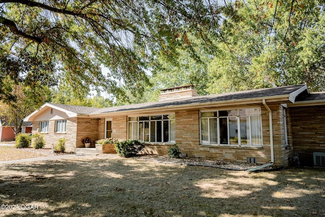 410 N Eisenhower St, Monett, MO 65708 - view of front of house with a chimney and stone siding