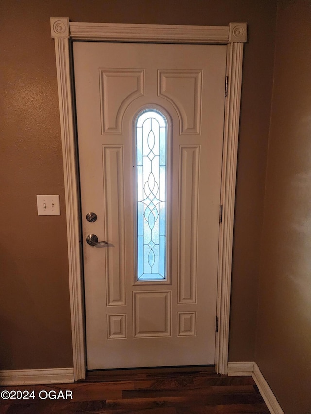 entryway with dark hardwood / wood-style flooring