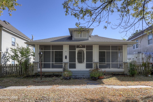 bungalow-style home with a sunroom