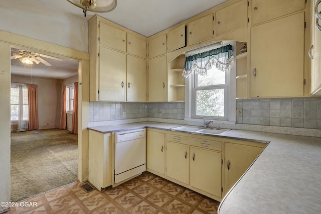 kitchen with cream cabinetry, white dishwasher, sink, tasteful backsplash, and ceiling fan