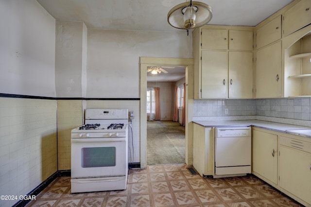 kitchen with white appliances, cream cabinetry, ceiling fan, tile walls, and pendant lighting