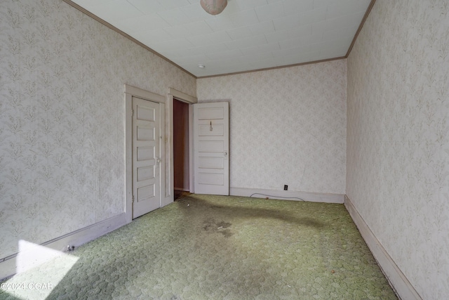 carpeted spare room featuring ornamental molding