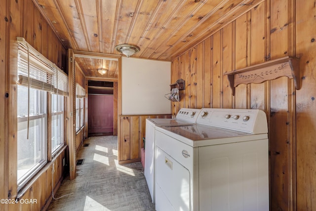 washroom with wood ceiling, independent washer and dryer, light parquet flooring, and wood walls