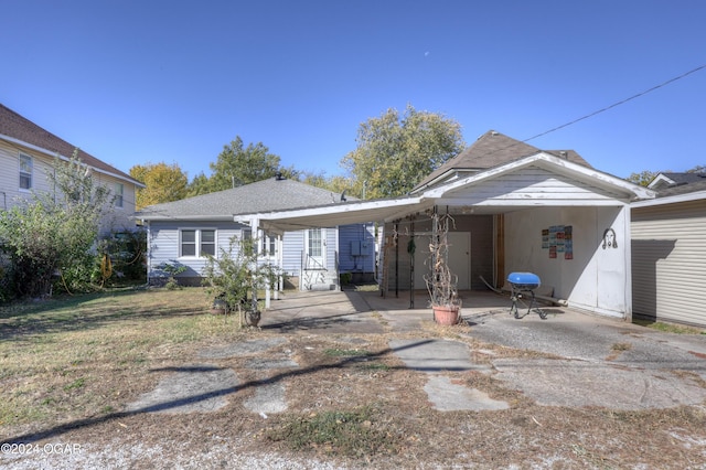 view of front of property featuring a front yard and a carport