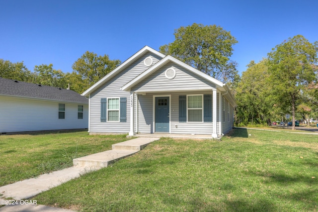 bungalow-style house with covered porch and a front lawn