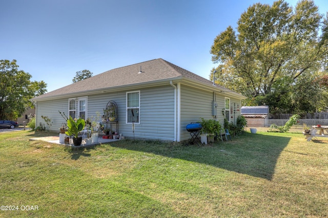 view of side of property with a yard