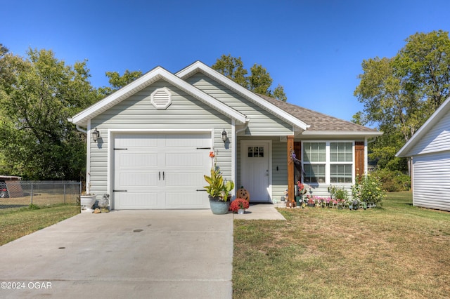 single story home with a front yard and a garage